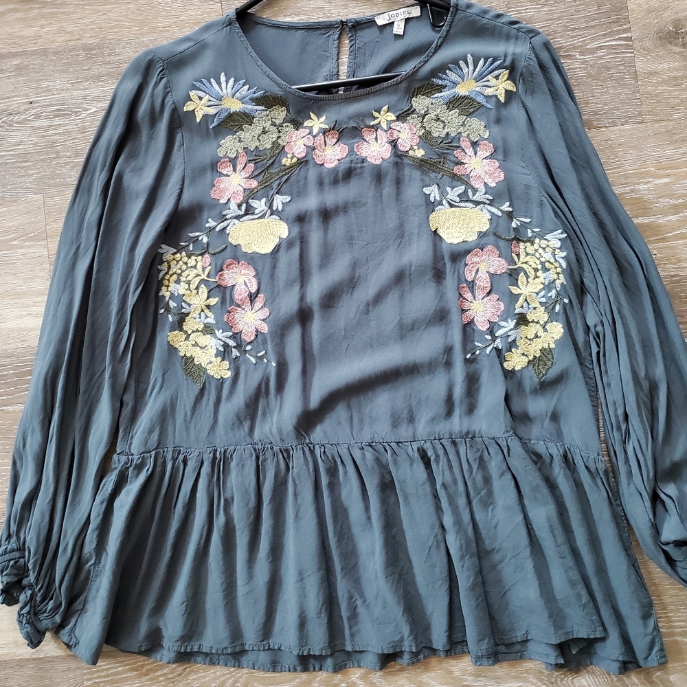 Embroidered floral ruffle bottom top